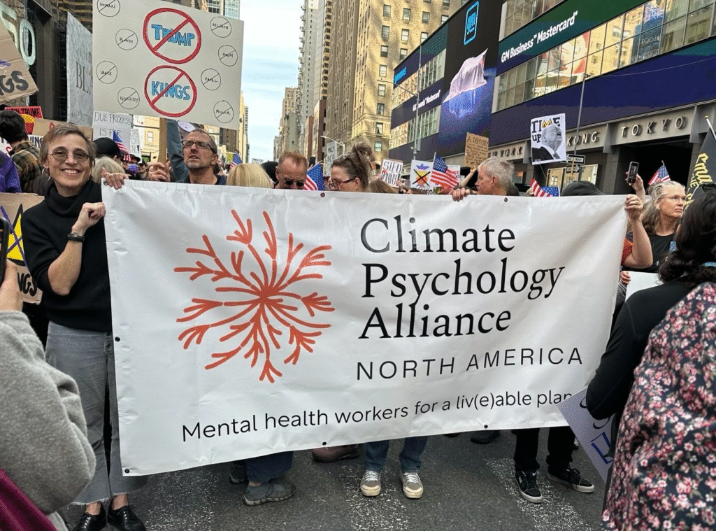 A group on a busy street holds a sign during a protest.